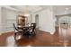 Bright dining room featuring hardwood floors, elegant chandelier, and built-in display cabinet at 9069 Blue Ridge Dr, Indian Land, SC 29707
