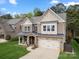 Charming two-story home featuring a brick facade, well-manicured lawn, and a two-car garage at 9069 Blue Ridge Dr, Indian Land, SC 29707