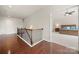 Spacious upstairs hallway with wood floors leading to a bedroom at 9069 Blue Ridge Dr, Indian Land, SC 29707