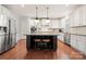 Modern kitchen features a large island with bar seating, stainless steel appliances, and custom cabinetry at 9069 Blue Ridge Dr, Indian Land, SC 29707