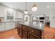 Kitchen with large island, pendant lighting, stainless steel appliances, and access to living area at 9069 Blue Ridge Dr, Indian Land, SC 29707