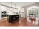 Open kitchen with island, stainless steel appliances, breakfast area, and hardwood floors at 9069 Blue Ridge Dr, Indian Land, SC 29707
