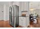 Bright kitchen with stainless steel refrigerator, white cabinets, and access to dining area at 9069 Blue Ridge Dr, Indian Land, SC 29707