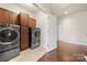 A laundry room features cabinetry, washer and dryer units, and access to another room at 9069 Blue Ridge Dr, Indian Land, SC 29707