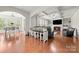 Open living space with hardwood floors, fireplace, custom shelving, and dining area at 9069 Blue Ridge Dr, Indian Land, SC 29707
