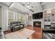 Comfortable living area showcasing a fireplace, coffered ceiling, and natural light from large windows at 9069 Blue Ridge Dr, Indian Land, SC 29707