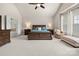 Spacious main bedroom with sitting area, tray ceiling and ensuite bath at 9069 Blue Ridge Dr, Indian Land, SC 29707