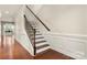 Elegant staircase with wood railing and wainscoting, leading to the upper level at 9069 Blue Ridge Dr, Indian Land, SC 29707