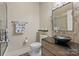Unique bathroom with a decorative mirror and a modern vessel sink on a wooden cabinet at 9069 Blue Ridge Dr, Indian Land, SC 29707