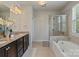 Bathroom features a dual vanity, soaking tub, and walk-in shower with tiled surround at 9069 Blue Ridge Dr, Indian Land, SC 29707