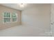 Neutral bedroom with carpet, natural light from the window, and white walls at 9069 Blue Ridge Dr, Indian Land, SC 29707