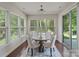Bright breakfast nook with many windows, a modern chandelier, and seating for four at 9069 Blue Ridge Dr, Indian Land, SC 29707