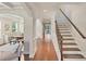 Elegant hallway features hardwood floors, staircase, and seamless transition to adjacent rooms at 9069 Blue Ridge Dr, Indian Land, SC 29707