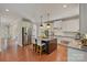 Spacious kitchen boasts island with seating, stainless steel appliances, and opens to living areas at 9069 Blue Ridge Dr, Indian Land, SC 29707