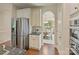Kitchen area featuring stainless steel refrigerator and view into formal dining room at 9069 Blue Ridge Dr, Indian Land, SC 29707