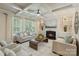 Inviting living room features a cozy fireplace, built-in shelves, and coffered ceilings for comfortable gatherings at 9069 Blue Ridge Dr, Indian Land, SC 29707
