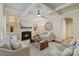 Bright living room with fireplace, built-in shelves, and coffered ceilings provides an inviting and stylish space at 9069 Blue Ridge Dr, Indian Land, SC 29707