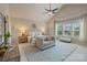 Bright main bedroom features a vaulted ceiling, ceiling fan, sitting area, and large windows at 9069 Blue Ridge Dr, Indian Land, SC 29707