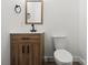 Bathroom featuring wooden vanity, modern sink, toilet, and vanity mirror at 908 Woodside Dr, Kings Mountain, NC 28086