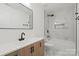 Modern bathroom featuring a sleek double vanity, stylish black fixtures, and a luxurious tub with marble tile surround at 908 Woodside Dr, Kings Mountain, NC 28086