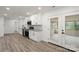 Modern kitchen with white cabinets, stainless steel appliances, granite countertops, and laminate flooring at 908 Woodside Dr, Kings Mountain, NC 28086