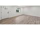 Bright, open-concept living room featuring new laminate flooring, white walls, and modern lighting at 908 Woodside Dr, Kings Mountain, NC 28086