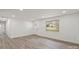 Bright, open-concept living room featuring new laminate flooring, white walls, and modern lighting at 908 Woodside Dr, Kings Mountain, NC 28086