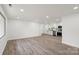 Bright, open-concept living room with new laminate flooring and a view of the modern kitchen at 908 Woodside Dr, Kings Mountain, NC 28086