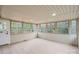 Bright sunroom featuring tile flooring, neutral paint, and multiple windows with backyard views at 908 Woodside Dr, Kings Mountain, NC 28086