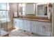 Bathroom features a double vanity with granite countertops and white cabinetry at 9319 Kestral Ridge Dr, Charlotte, NC 28269