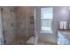 Bathroom featuring tiled shower and window providing natural light at 9319 Kestral Ridge Dr, Charlotte, NC 28269