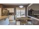Eat-in kitchen dining area features white cabinets, stainless appliances, and a view of the landscaped backyard at 9319 Kestral Ridge Dr, Charlotte, NC 28269