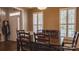 Dining room with dark wood floors, shutters on windows, and traditional table and chairs at 9319 Kestral Ridge Dr, Charlotte, NC 28269
