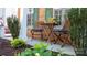 Quaint front porch with seating, green shutters, and brick columns in a landscaped setting at 9319 Kestral Ridge Dr, Charlotte, NC 28269