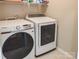 Bright laundry room featuring side-by-side Samsung washer and dryer units at 9319 Kestral Ridge Dr, Charlotte, NC 28269