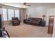 Inviting living room with leather furniture, lamps, and neutral carpet at 9319 Kestral Ridge Dr, Charlotte, NC 28269