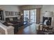 Cozy living room offers hardwood floors, a fireplace, and sliding glass doors to the outdoor space at 9319 Kestral Ridge Dr, Charlotte, NC 28269