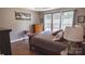 Comfortable main bedroom featuring hardwood floors, a dresser, and a large window at 9319 Kestral Ridge Dr, Charlotte, NC 28269