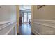 View of a well-lit primary bedroom with tray ceilings, wood floors, and large windows at 9319 Kestral Ridge Dr, Charlotte, NC 28269
