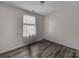 This bedroom has lovely wood floors, neutral walls, and a window for plenty of natural light at 98 Poplar Woods Dr, Concord, NC 28027