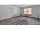Bedroom with wood floors, a ceiling fan, and a door, showcasing the room's layout and design at 98 Poplar Woods Dr, Concord, NC 28027