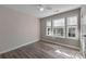 Bright bedroom with a ceiling fan and three windows offering great natural light and backyard views at 98 Poplar Woods Dr, Concord, NC 28027