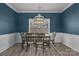 Dining room featuring modern light fixture, and wainscotting at 98 Poplar Woods Dr, Concord, NC 28027