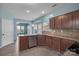 Well-equipped kitchen featuring stainless steel appliances, dark cabinets, and an eat-in kitchen space at 98 Poplar Woods Dr, Concord, NC 28027