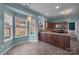 Kitchen featuring wood cabinets, tile floors, stainless appliances and natural light from three windows at 98 Poplar Woods Dr, Concord, NC 28027