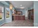 Bright kitchen with an island bar, stainless steel appliances, and a breakfast area by the window at 98 Poplar Woods Dr, Concord, NC 28027