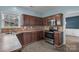 Beautiful kitchen showcasing stainless steel appliances, dark wood cabinets, and a breakfast nook at 98 Poplar Woods Dr, Concord, NC 28027