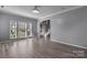 Bright living room with hardwood floors, large windows, and an open view of the staircase at 98 Poplar Woods Dr, Concord, NC 28027
