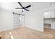 Bright room with hardwood floors, ceiling fan, sliding barn door and an adjoining office space at 103 Park Ave, Mount Holly, NC 28120