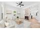Bright living room featuring a brick fireplace, hardwood floors, and an open concept design at 103 Park Ave, Mount Holly, NC 28120